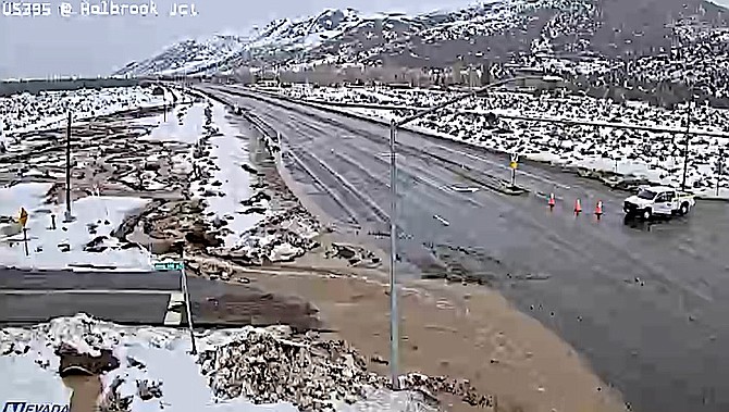 Water flows out onto Highway 395 at Holbrook Junction on Friday morning.