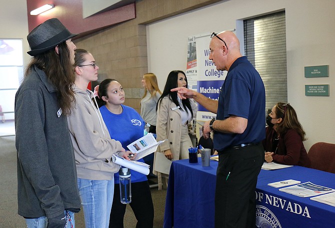 State of Nevada personnel analyst Jon Terrezas, right, talks to students, including Benny Buchanan, far left, about job opportunities and programs in various departments during Western Nevada College’s WCTE Career Fair and Open House Day on March 6.