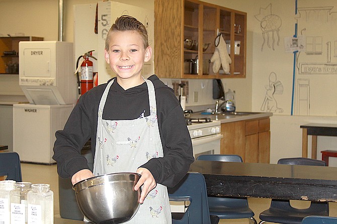 Sixth-grader Paxton Rasmussen stirs up a bowl of Gofundme to raise money for Carson Valley Middle School’s culinary program on Monday. Students have taken charge of funding the kitchen.