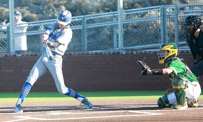 Cooper Eaton connects for a base hit against Bishop Manogue on Thursday. Eaton has been Carson’s third baseman so far this season.