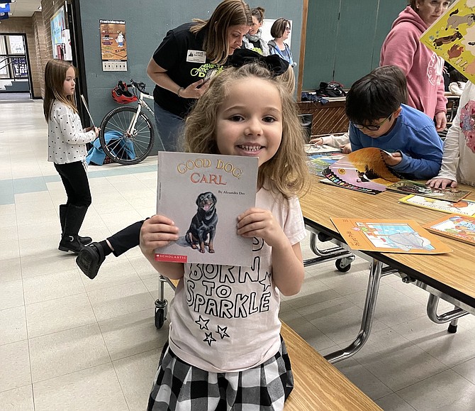 Bordewich Bray Elementary kindergartner Charlotte Sharpsteen, 5, picks out a book from the Ride for Reading event on March 21.