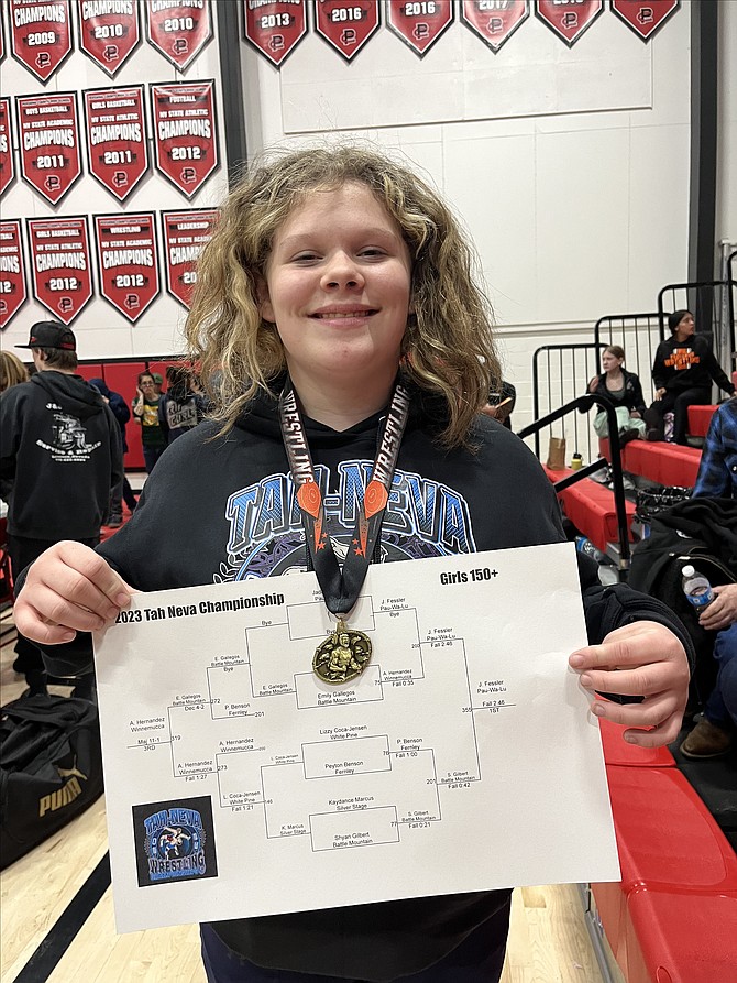 Pau-Wu-Lu's Jada Fessler poses for a photo with her bracket after winning her weight class at the middle school wrestling championships this past weekend.