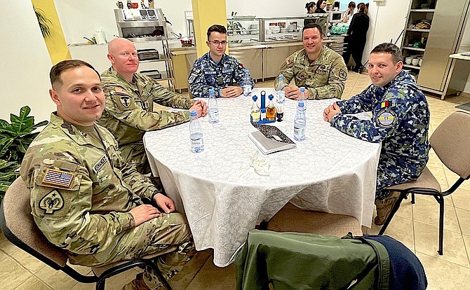 Nevada Army National Guard 137th Military Police Co., commander Capt. Bryan Hernandez, left and Sgt. 1st Class Daniel Rogers, along with battalion commander Lt. Col. Curt Kolvet, second from right, have lunch with their Romanian counterparts.