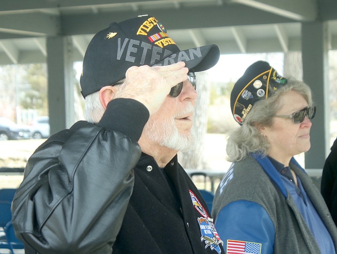 Vietnam veteran Roger Diez salutes after the reading of names of Nevada’s fallen Vietnam War veterans at Saturday’s remembrance ceremony at Mills Park.