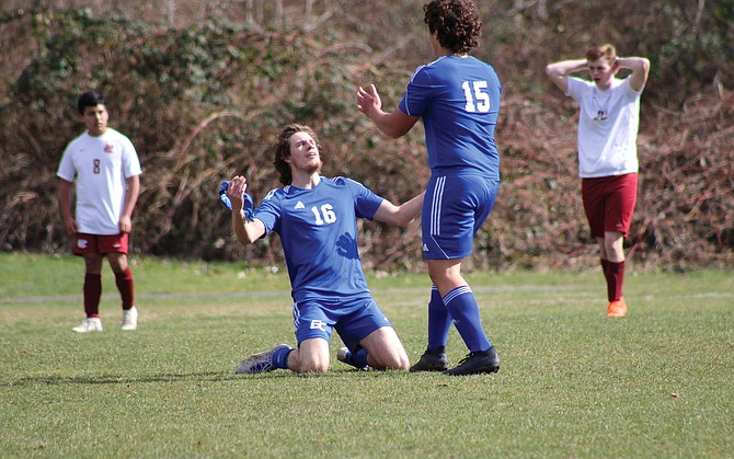 Riley Rockey kneels as he celebrates one of his four goals against Hoquiam on Saturday. Kevin Tomyn, who had the assist on the goal, looks on.