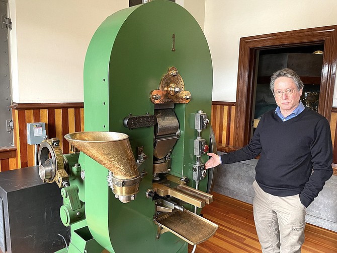 Myron Freedman, administrator of the Nevada Division of Museums and History, shows off Coin Press No. 1 at the Nevada State Museum in Carson City on Tuesday.