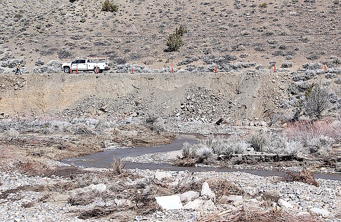 A work truck on Fish Springs Road above where Pine Nut Creek undermined the bank during flooding earlier this month.