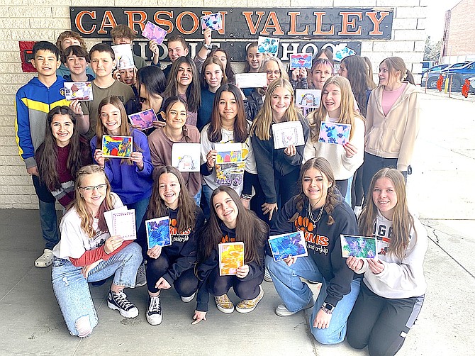 The Carson Valley Middle School Leadership class presented Between Horses and Humans Program Manager Jeannette Bostedt a check for $500. The class voted to give back to their community and donate a portion of the proceeds from their "Winter Nights and Shining Lights" dance in December. Other recipients include Douglas County Animal Shelter and the Nevada Humane Society. In the picture the leadership students are holding cards made from paintings by the  horses and drawings from the participants.