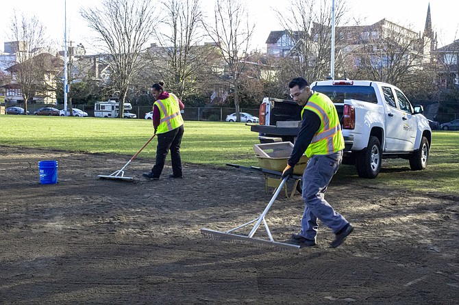 Parks and Recreation Department staff smooth out one of the fields at Big Howe Park in Upper Queen Anne last month. Often, Little League volunteers have to grade and prep the fields for games when city staff aren’t available or the fields are torn up because of dogs.