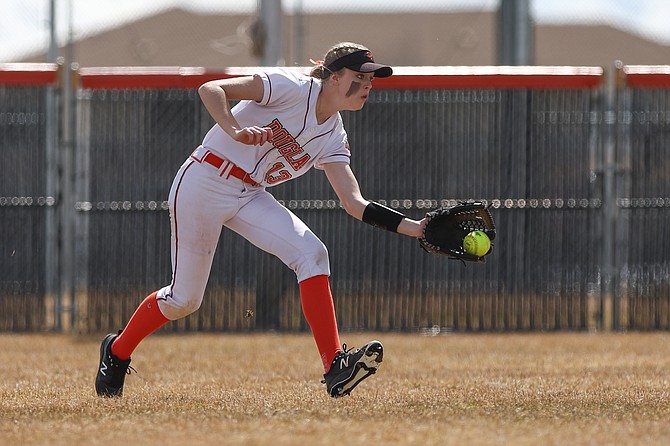 Maddie Gooch of Douglas high softball leans in to make a grab in the outfield, during a contest earlier this season. Gooch went 5-for-8 in three games Saturday and drove in three RBIs in the Tigers’ win over Carson.
