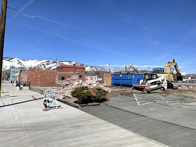 A demolition crew from Olcese Construction knocking down three buildings on April 5. The structures stood near the corner of East Washington and North Plaza streets. Demolition was expected to be finished by April 11, according to the construction company.