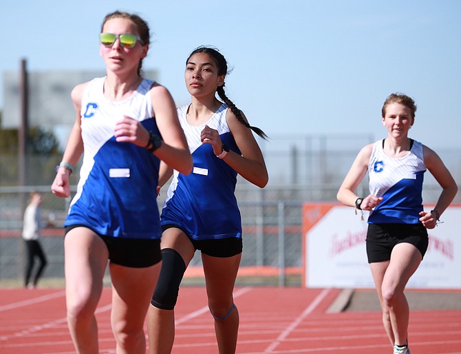 Three of Carson High’s girls distance runners – Jinnie Ponczoch, Brianna Rodriguez-Nunez and Eleanor Romeo, from left to right – round the corner at Douglas’ league meet April 5. Carson has three of the top 10 times in the 1,600 and four of the top 20 times in the 3,200 in the North this season.
