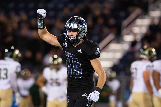 Chris Smalley holds his fist up after a play this past fall, during his freshman season with Nevada football. Smalley is a Douglas High alum and is gearing up for his second season with the Wolf Pack this spring.