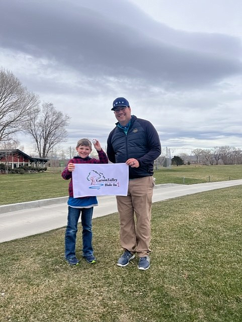 Matthew Vaillancourt and Carson Valley Golf Course head golf pro, Dan D’Angelo, pose for a photo after Vaillancourt hit a hole-in-one, during the opening day of the PGA Jr. League at the Carson Valley Golf Course.