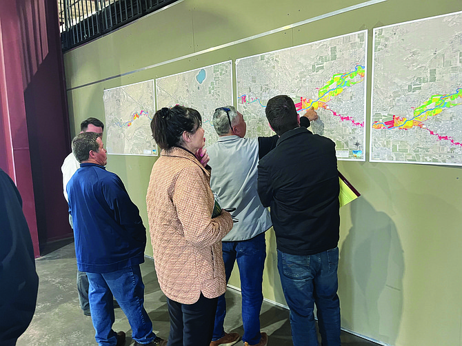 County residents study the Carson River water flow maps after a recent town hall meeting on flood mitigation.