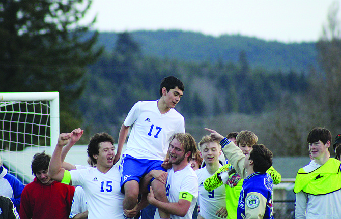 Eatonville’s Victor Peña Moreno gets lifted on the shoulders of his teammates after his penalty kick sealed the victory for the Cruisers against Forks last week.