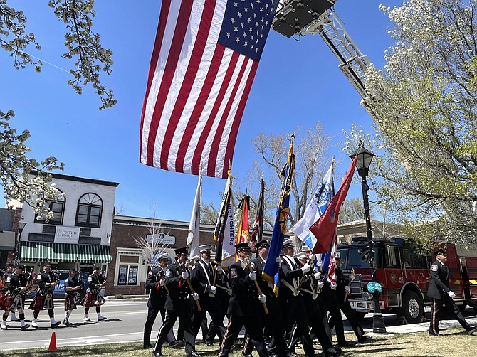 A firefighter honor guard exits Carson Street on April 27, 2023 and heads toward a new memorial at the Capitol honoring fallen firefighters.