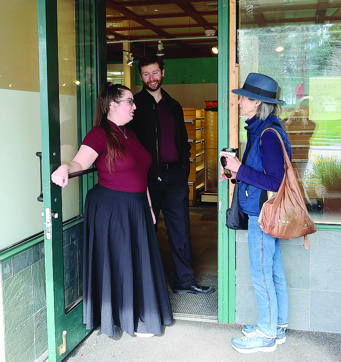 Madison Park Pharmacy and Wellness Center owner Matt Binder and retail manager Laura Sorensen talk to a customer in the doorway of the new pharmacy in Madison Park, which will replace Pharmaca after the longtime business closed in February.