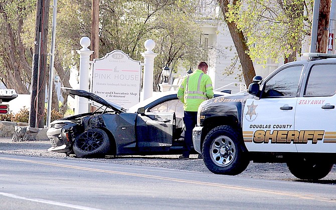 A black sedan had to be towed after colliding with a power pole in Genoa on Thursday morning.