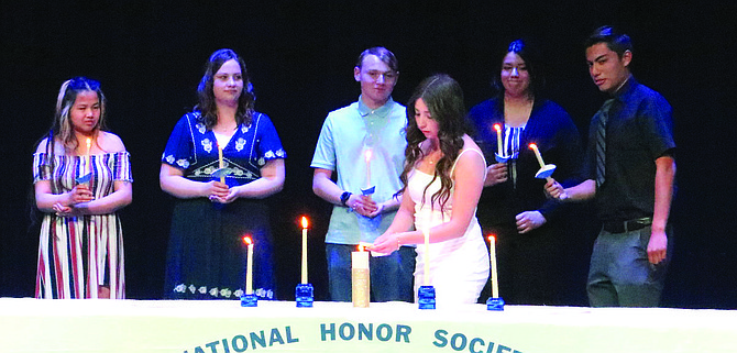 Chapter officers with the Churchill County High School National Honor Society are, from left, Sonialynn Natividad, Camille Winder, Gerik Wassmuth, Annalee Reyna, Cameron Christy and Ruth Ibarra, lighting the candle.