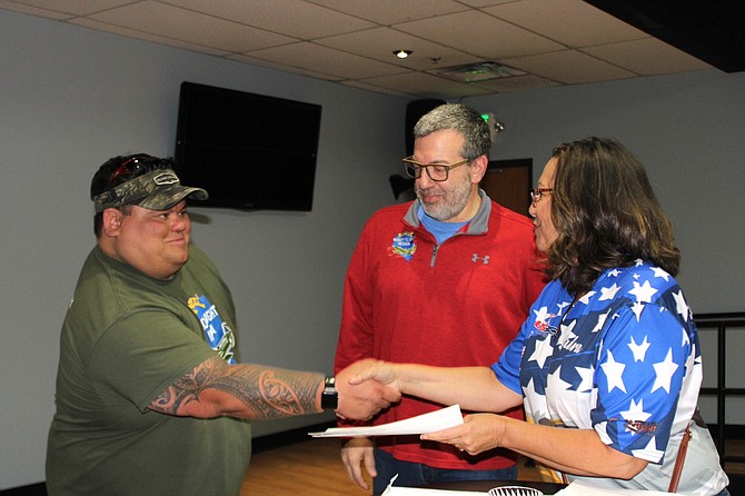 Carson Country Bowling Association board member Sandra Hibler presents a check for $5,519 to Ben Johnson and Jon Yuspa of Honor Flight Nevada.