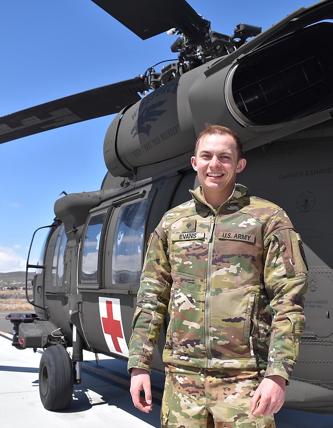 Nevada Army Guard Spc. Jake Evans, a graduate of Douglas High, stands next to a medical evacuation UH-60L Black Hawk helicopter during a break in training on April 17 in Reno.  
Photo by Sgt. 1st Class Erick Studenicka, Nevada Army Guard