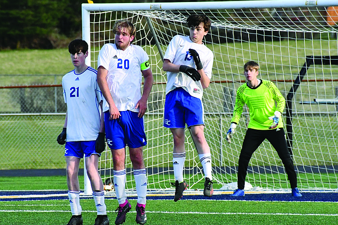 Eatonville’s Jake Brannon, Josiah Goode and AJ Lightfoot form a wall in front of goalkeeper Nathaniel Goode during a defensive battle against Tenino last week.