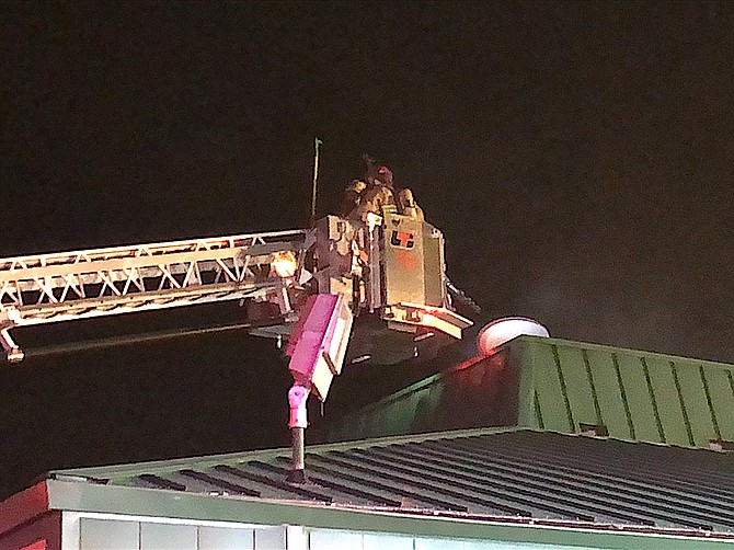 Chief Tod Carlini sent this photo of the ladder truck crew working on the roof of a commercial center in downtown Gardnerville on Monday morning.