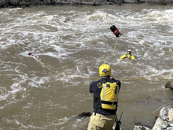 CCFD Firefighter Paramedic Jack Reynoso throws Bret Waszkiewicz a line during swift water rescue training on the Carson River on May 5.