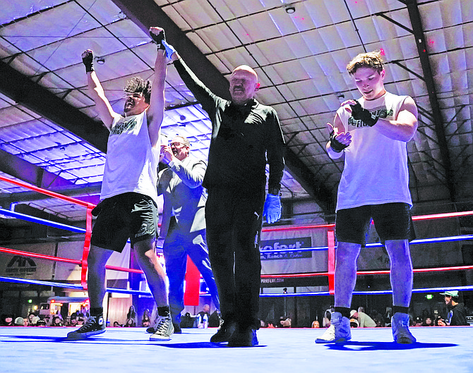 Referee Bert Serrano raises Jose Ruiz’s hand as Jared Dooley announces that he defeated Duston Drinkut in the main event of Friday’s Night of Fights at the Rafter 3C Arena.