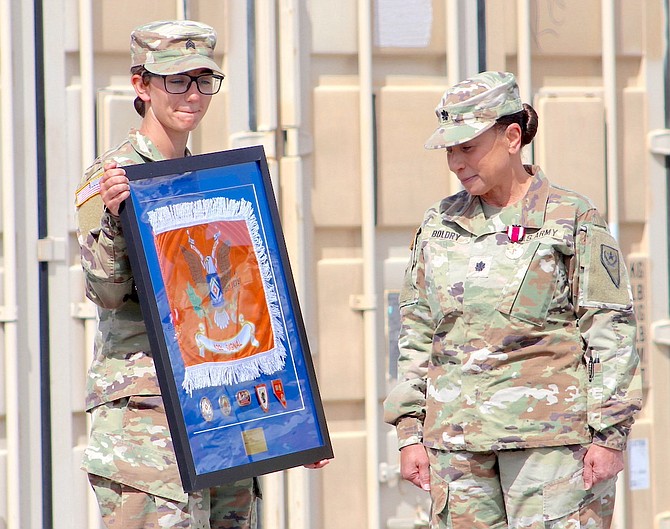 A soldier with the 422nd Expeditionary Signal Battalion of the Nevada Army National Guard presents a gift to outgoing commander Lt. Col. Laura Boldry at Sunday’s change of command ceremony.