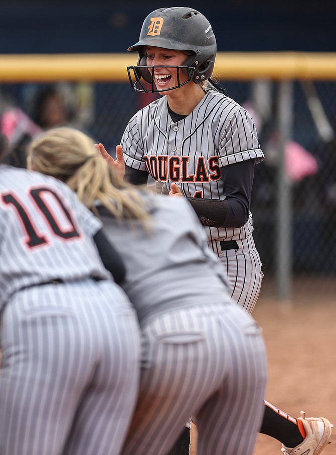 Douglas High’s Cam McClelland smiles before touching home plate after hitting a home run in the fifth inning of the Tigers’ win over Carson on Saturday. McClelland’s home run was the 57th for Douglas this season, the second most in a single season in NIAA history.