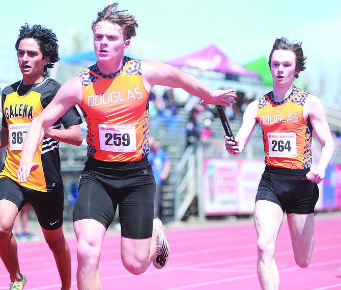 Douglas High’s Kevin O’Connell, right, hands the baton to Connor Jackson during the Tigers’ 4x200 meter relay at the Big George Invite at the end of April.