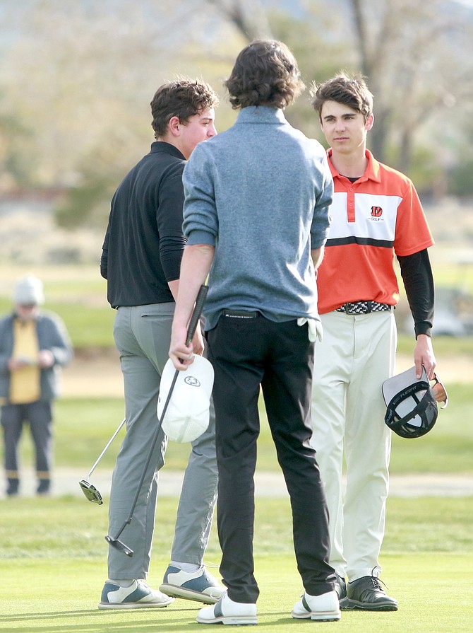 Douglas High’s Brock Walters shakes the hand of Reno’s Ryan Cavanaugh after finishing as the Class 5A North boys regional champ at Sierra Sage Golf Course on Tuesday. Walters won the regional crown with a 75-70–145, winning the title by five strokes.
