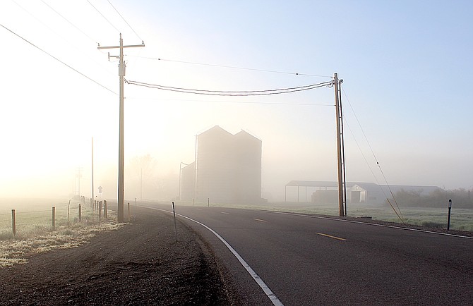The Settelmeyer silos along Genoa Lane loom in the fog on Monday morning.