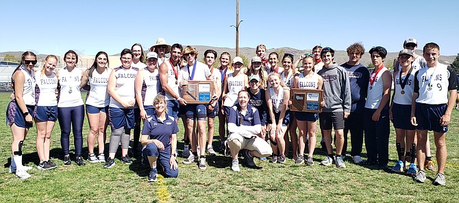 The Sierra Lutheran High School track and field team poses with both the Class 1A boys and girls regional championship plaques at Reed High School on Saturday.