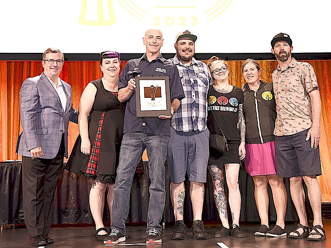 Shoe Tree Brewing staff accept a bronze award in the 2023 World Beer Cup.