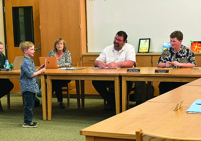 An Eatonville Elementary School student presents his artwork to the School Board at the May 10 meeting.