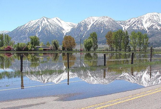 The Carson Range is reflected in the water that closed Mottsville Lane on May 17. A flood watch remains in effect until 8 p.m. May 22.