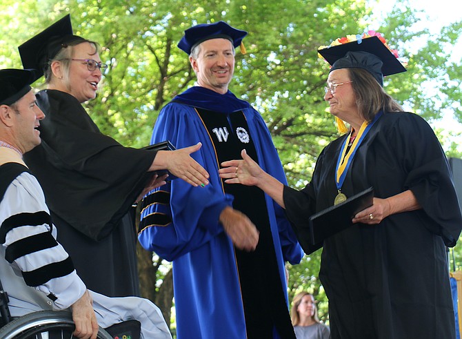 Western Nevada College graduate Pamela DeWitt, right, receives her diploma from President Kyle Dalpe, Center, Vice President of Academic and Student Affairs Dana Ryan and Nevada System of Higher Education Board of Regents Vice Chair Joseph Arrascada. DeWitt, 63, graduated for the first time Monday and said she would seek a state job.