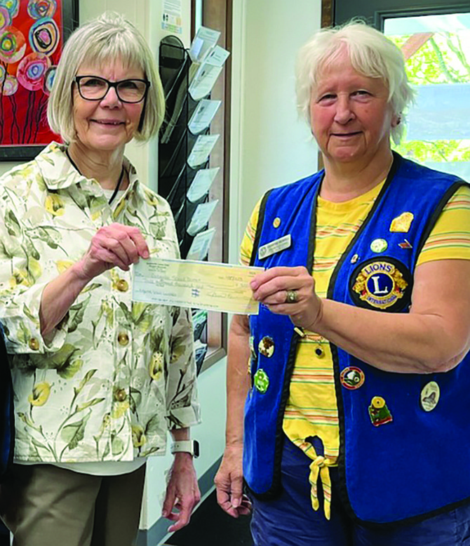 Eatonville Lion Chris Wendell presents Eatonville interim Superintendent Lucy Fountain with a check for $3,000. The money was raised at the Lions Club Casino Night March 18.