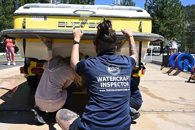 Lake Tahoe watercraft inspectors hunt for invasive species on a boat at the inspection station in Meyers, Calif.