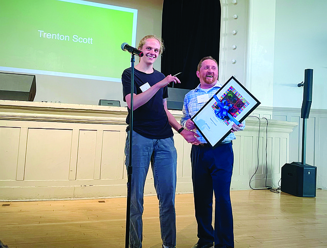 Queen Anne resident Trenton Scott, left, and Ben Wahl, the founder of Aspiring Youth and Delphi Young Adults Program, smile after Wahl presented Scott with the Youth Advocate Award at the Ryther’s NeurodiverseNW '23 event.