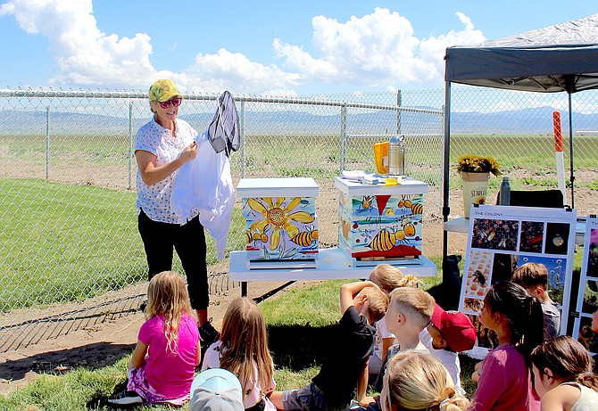 Beekeeper Daunelle Wulstein demonstrates protective clothing to Minden Elementary School students at Ag in the Classroom on Tuesday morning.