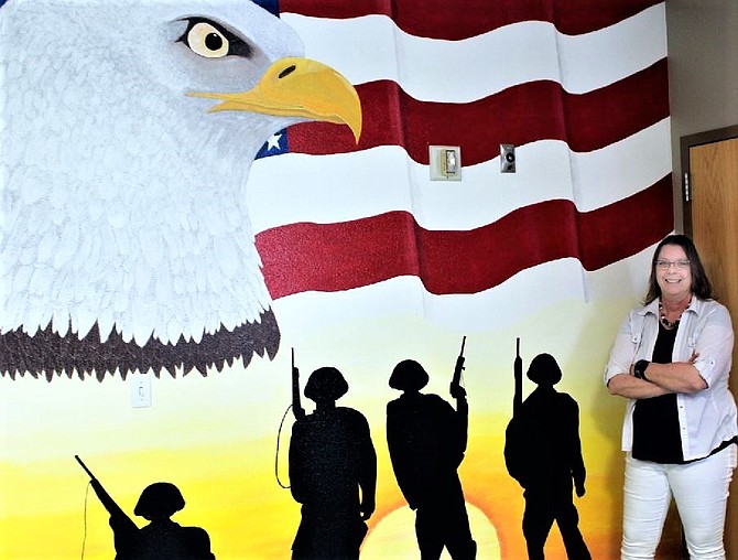 Cherrice Dotson hand painted the mural at the entrance of the redecorated Veterans Resource Center at Western Nevada College.