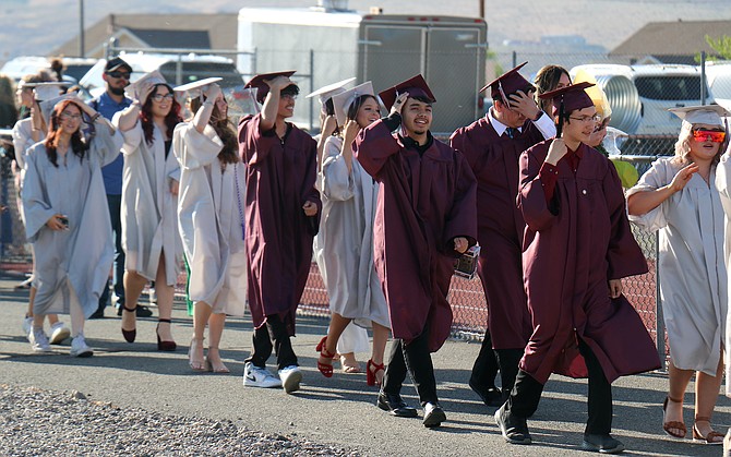 Dayton High School graduates enter the high school football field for their processional during commencement Thursday.