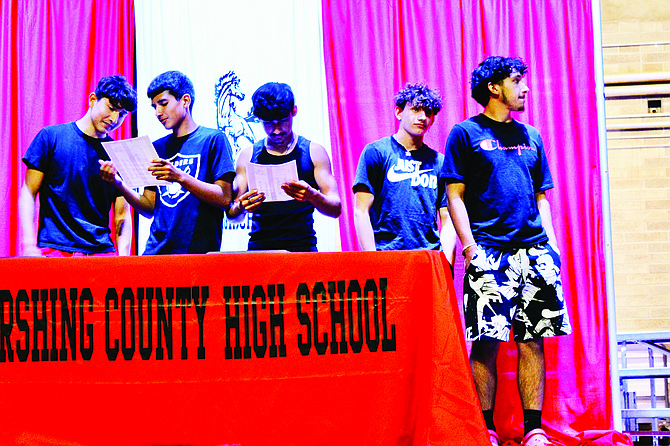 Denzel Zaldivar, Ramon Sanchez, Ashton Jimenez, Josiah Hunt and Luis Sanchez stand on the auditorium stage on awards night.