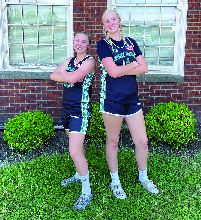 Eatonville High School juniors Bailey Andersen and Lilian Bickford pose prior to a summer league game. The girls are raising money to compete in a basketball tournament in London in late June.