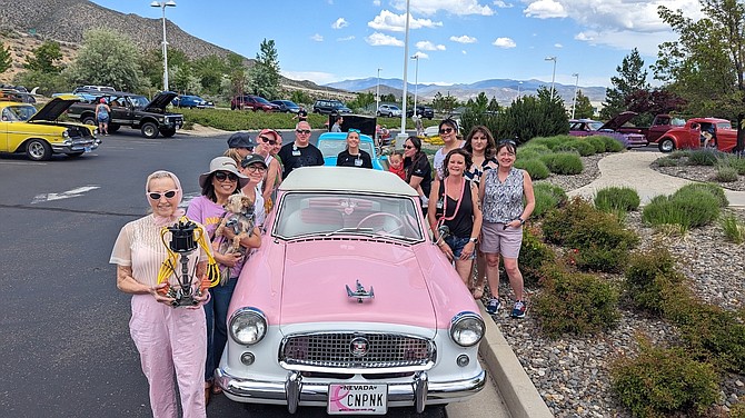 Holly McGee and her first place 1959 Nash Metropolitan, with Carson Tahoe Cancer Center Team.