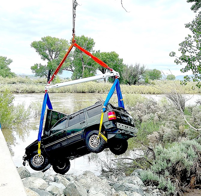 A Jeep Cherokee is hoisted out of the Carson River at Cradlebaugh Bridge. Nevada State Police photo